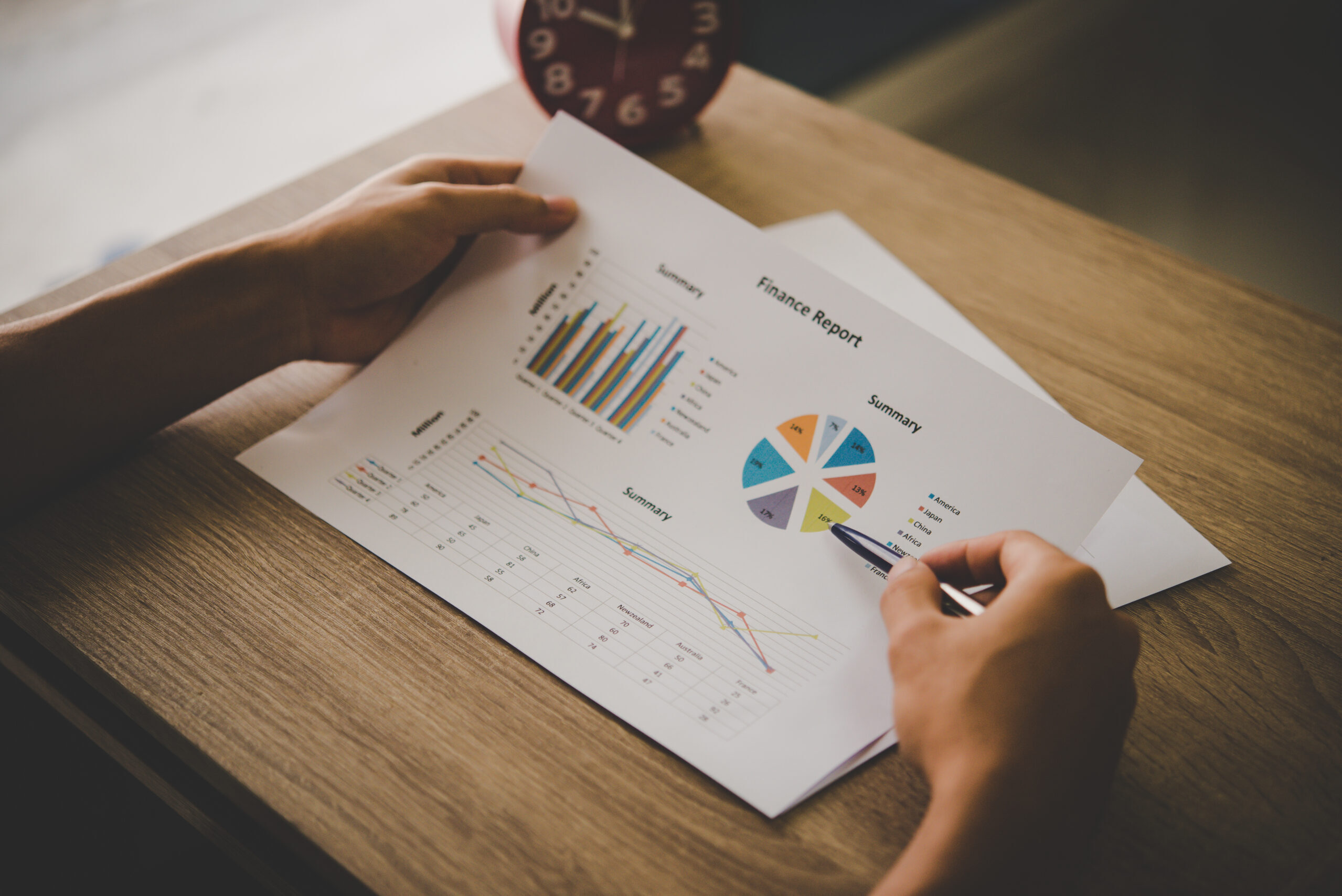 Businessman holding and analyzing investment chart working in of